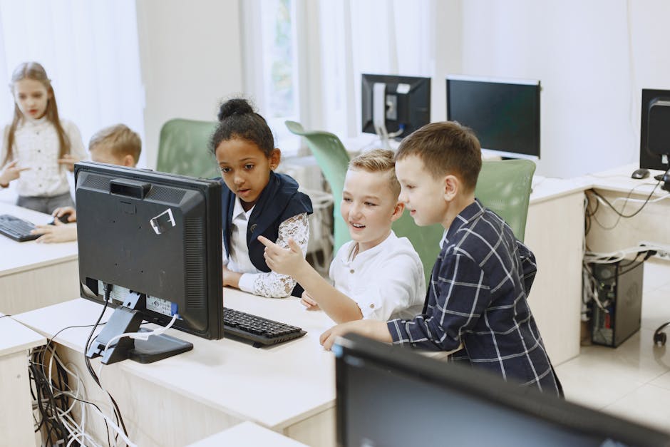 Young students engaging with computers in a modern classroom setting